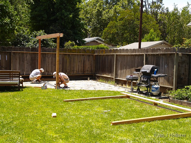 _6169679.JPG - Having verified the plumb, we secured the 4X4's into the pre-installed fence post holders. This way, if the boards ever rot, we can easily remove & replace it.