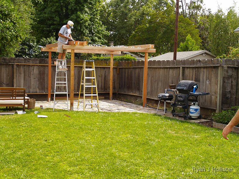 _6169689.JPG - Time for the fun stuff!  The cross beams went in easily enough, but we had to measure and install three spacers between each of the boards we installed.  It was hard screwing the boards together with very little room to work.