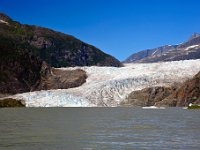 Mendenhall Lake looks gray and silty because the glacier grinds and powderizes rocks that it flows over coming down the valley.  The sediments created (called glacial flour) get washed into the lake by under-glacier streams or glacial calving.  They are so small that they stay suspened for a long time.