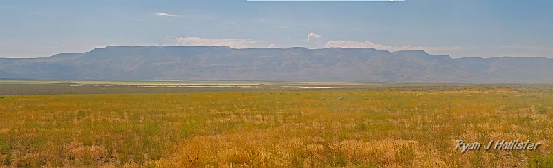 lakemerge.jpg - It's a lonely area outside of Plush, Or.  This shot is of a classic basin & range grabben (a dropped piece of crust) that is now home to Flagstaff Lake (among others).  The Hart Mountains are the horst jutting sharply out of the ground.