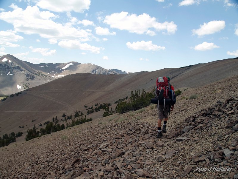 20090810_high_emigrant_lake_0182.jpg - Time for the first fun downhill.  We didn't take the switchbacks in the background.  There's a much more direct (steeper) route that meets up where the trees and road connect.