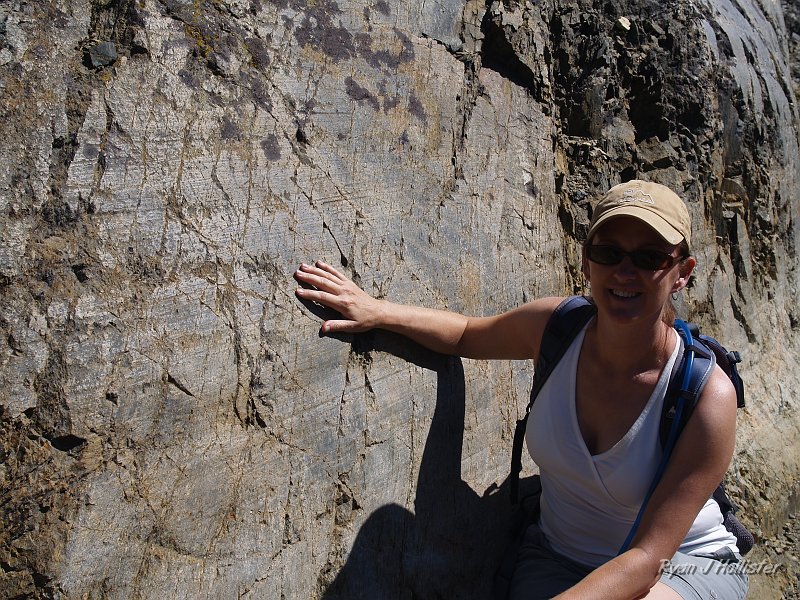 20090816_20_Lakes_Basin_0337.JPG - Laura models the amazing glacial polish & gouge marks left behind during the last Ice Age that reached its peak about 18,000 years ago on this vertical wall.