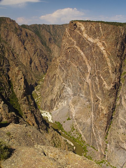 _6233294.JPG - Just so you know... the exposed black schist is 1.7 BILLION years old, and the pegmatites intruded them 1.4 Billion years ago.  These rocks were essentially at the bottom of a huge mountain range, maybe 5 miles beneath the crust.  This is what the Himalayas should look like if we could explore that far down today.