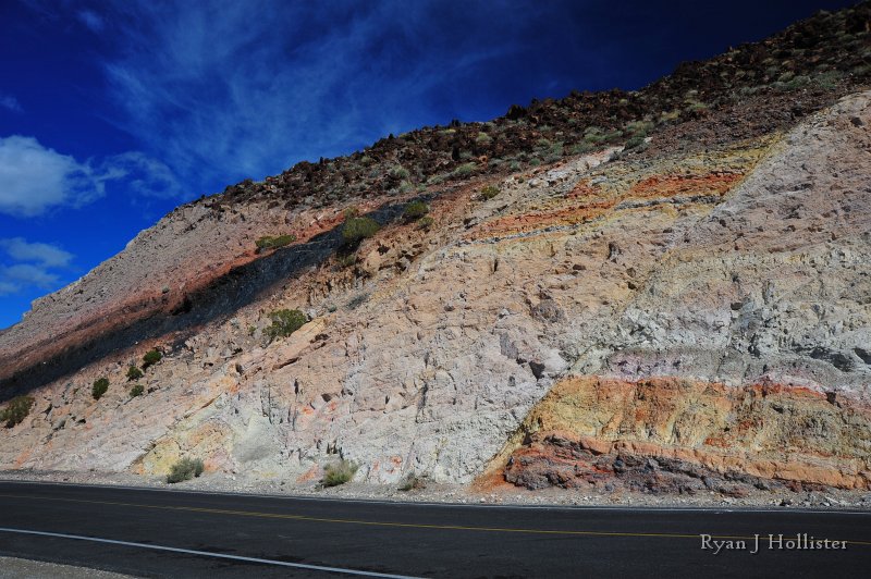RJH_7883.JPG - Charlie Brown Outcrop.  The black seam is not coal, rather volcanic glass created by super-hot ash falls insulating and re-melting an ash-fall.  There is also a very prominent normal fault at right that many people have mistaken for a reverse fault.