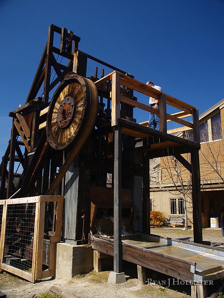_3147121.JPG - The gentleman from the museum engages the stamps with a large piece of wood.