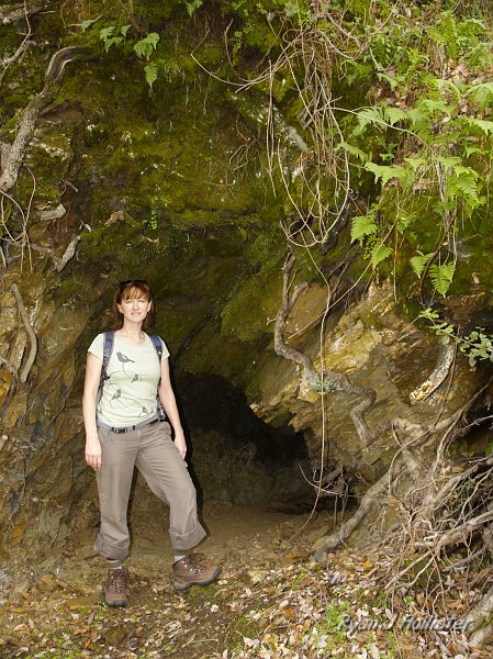 indian_creek_011610_1263.JPG - Laura stands at the entrance to the mine adit... the reason for the road's construction.