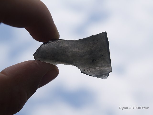 _7124157.JPG - Hey, we must be getting close!  This is an obsidian flake, probably from the volcanic fields of the Mono/Inyo craters area.