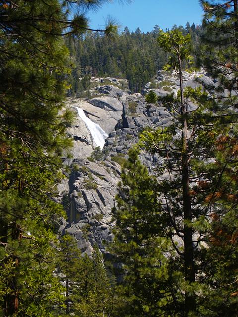 _6012389.JPG - After lots more hiking, we finally see the first hints of the upper falls.  Note that it disappears behind a huge fissure caused by some impressively large-scale jointing.