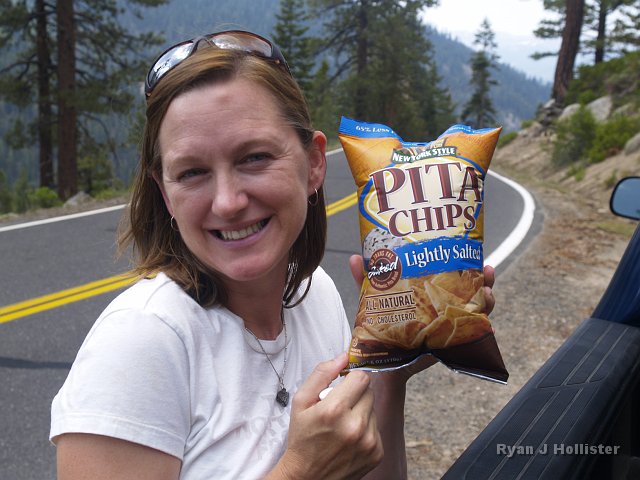 _7124125.JPG - Laura happily displays atmospheric science!  The air pressure at 8000 feet (2440m) is about 79% of the pressure exerted at sea level.  The pressure of the gas in our sealed bag of our Pita Chips was probably near the pressure found at sea level, thus the higher pressure inside the bags forced the bag "poof" into the weaker air pressure where this picture was taken.