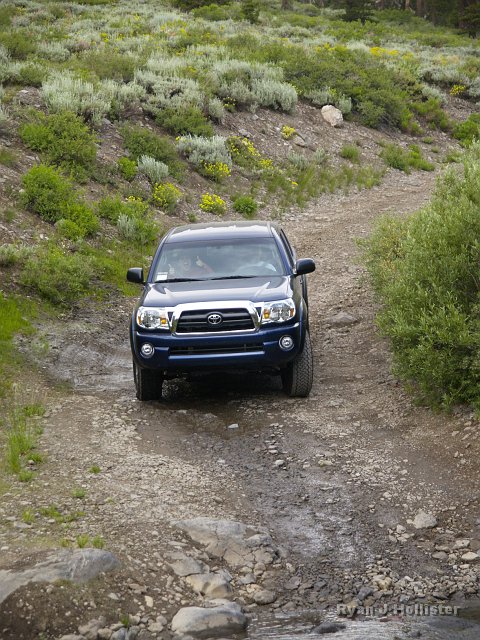 _7124211.JPG - Time to break-in the new Tacoma on Leavitt Lake Road.  Ericka gives a "Thumbs-up" to the crossing.