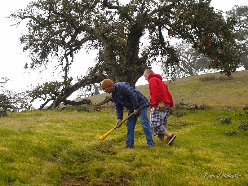 pacheco_120509_1030.JPG - Curtis gives a demonstration on how the pick is used to break new trail...
