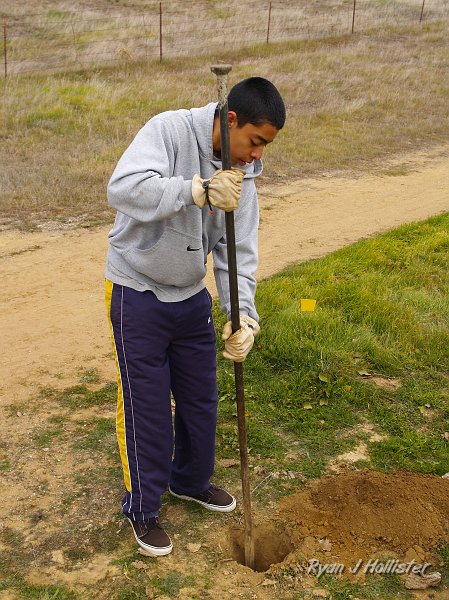 pacheco_120509_1039.JPG - Diego uses the pry-bar to break through the clay.