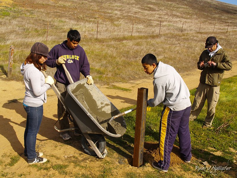 pacheco_120509_1041.JPG - Diego guides the concrete in the hole.